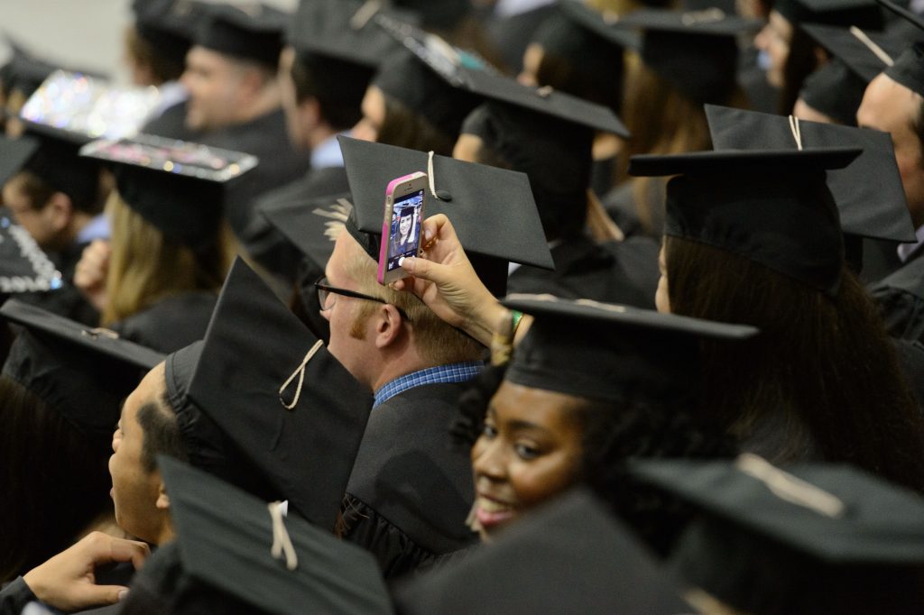 undergraduate taking a self-portait at commencement