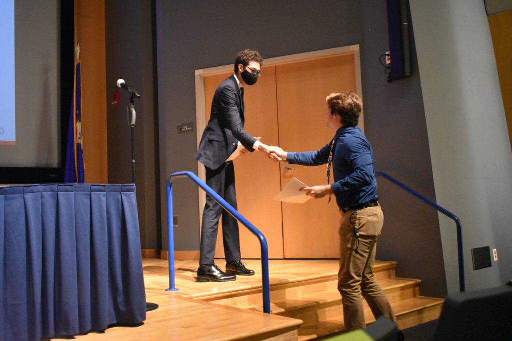 student being greeted on stage