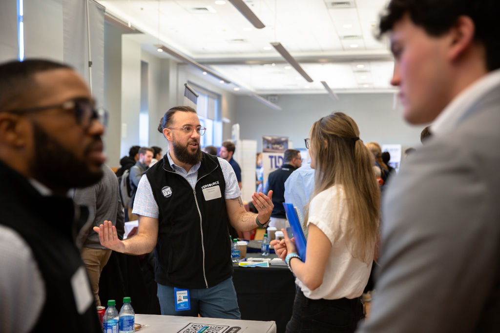 students at a career fair discussing opportunities